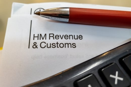 Official paperwork from HM Reveue & Customs with a pen and calculator