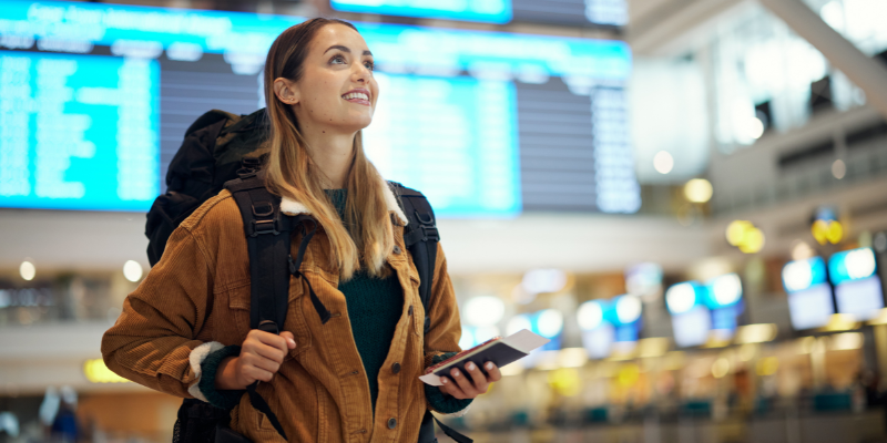 Woman in airport travelling to a different country.